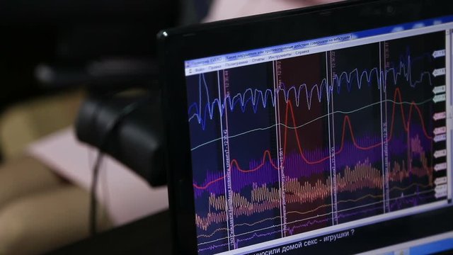 Lie-detector test, a woman answers the questions of the expert