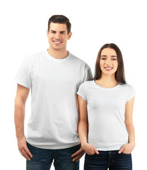 Fototapeta na wymiar Young man and woman in stylish t-shirts on white background. Mockup for design