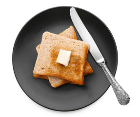Plate with toasted bread on white background