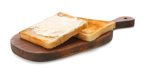 Wooden board with toasted bread on white background