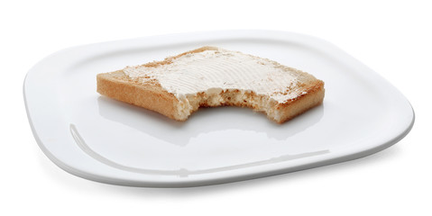 Toasted bread with bite mark on plate against white background
