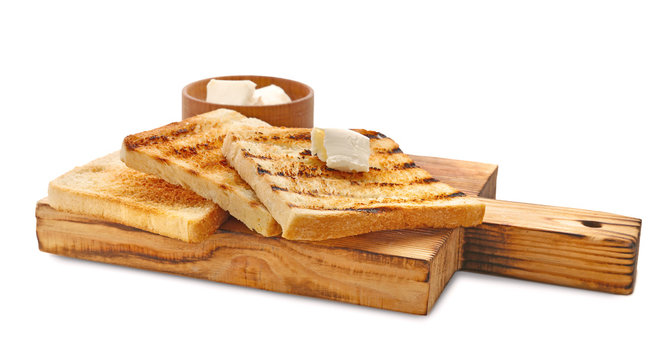 Wooden board with toasted bread and butter on white background
