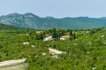 A small village is situated on a plain among the mountains.