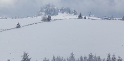 winter in the mountains - small Romanian village in the Carpathians covered with snow