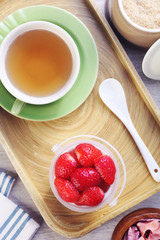 Delicious dessert panna cotta with strawberrieson wooden background