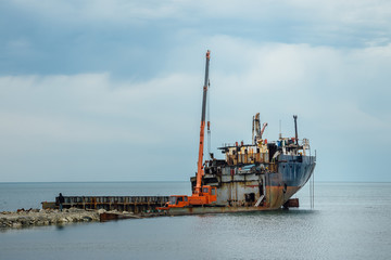 Dismantling of an old rusty ship to scrap metal