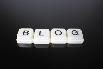 Blog text word title caption label cover backdrop background. Alphabet letter toy blocks on black...