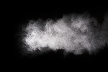Fototapeta na wymiar Freeze motion of white dust explosion on black background. Stopping the movement of white powder on dark background. Explosive powder white on black background.