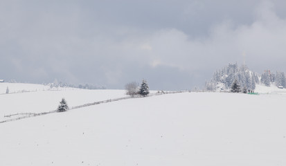 winter in the mountains - small Romanian village in the Carpathians covered with snow