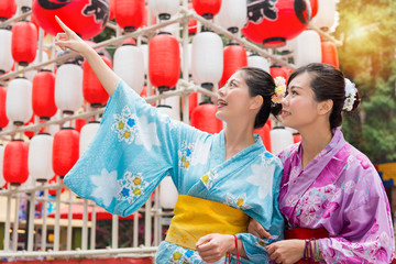 travelers standing in front of celebration lantern