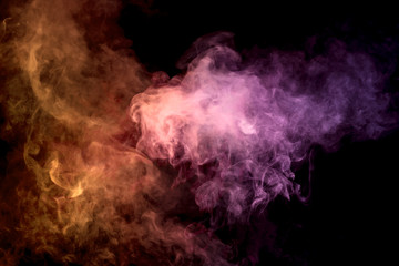 .Colorful orange and pink smoke clouds on dark background.Background of smoke vape.