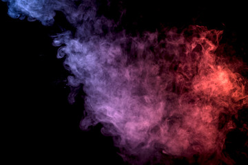 Thick colorful smoke of  purle and pink on a black isolated background. Background from the smoke of vape