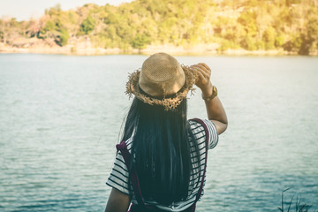 Woman tourist stand on the river surrounded by rivers and mountains.