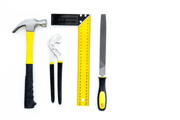 Tools for repair and building. Hummer, file, corner ruler on white background top view copy space