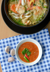 Sukiyaki soup with sauce on wood background