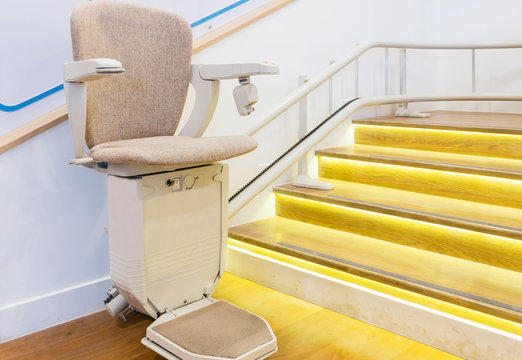 Automatic stair lift on staircase for elderly people and disabled persons