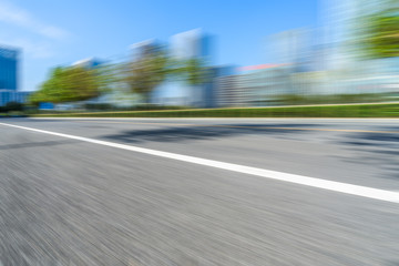blurred urban road with city skyline background in china.