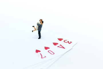 Fototapeta premium Miniature people: Couple hug each other to show love. Image use for Valentine's day concept.