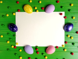 multicolored eggs on wooden green background 