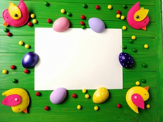 multicolored eggs on wooden green background 
