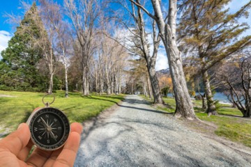 Compass with natural blur background. Travel concept.