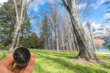 Compass with natural blur background. Travel concept.