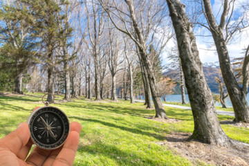 Compass with natural blur background. Travel concept.