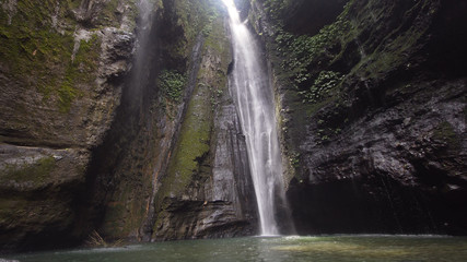 Waterfall in green forest in rainforest. Waterfall in the mountain jungle. Bali,Indonesia. Travel concept.