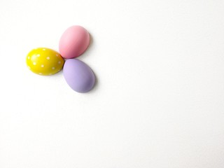 Fototapeta na wymiar colored eggs on a textured white background 