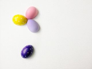 colored eggs on a textured white background  