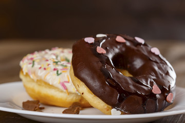Donuts in a white plate on the table