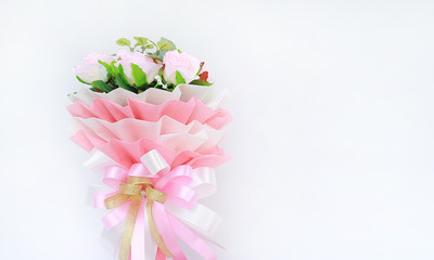 Artificial pink roses bouquet with copy space on white background.