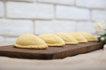 Traditional shekerbura as Novruz symbol on wooden board