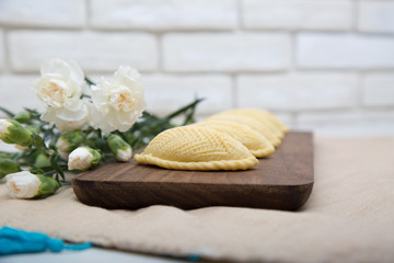 Traditional shekerbura as Novruz symbol on wooden board