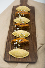 Traditional shekerbura and pakhlava as Novruz symbol on wooden board