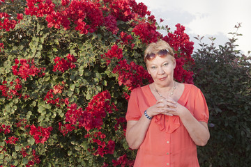 A woman of mature years in red dress