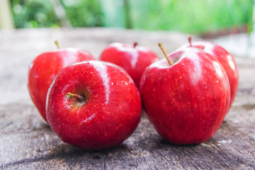 Red apples on the wooden table
