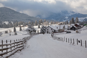 winter in the mountains - small Romanian village in the Carpathians covered with snow