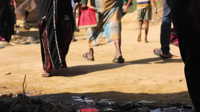 Residents make their way down a dirt road in Bangladesh