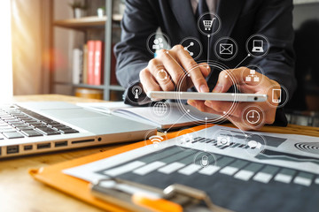  businessman hand working with laptop computer in modern office with virtual icon diagram at modernoffice in morning light 
