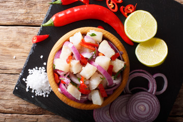 Freshly prepared ceviche from white fish with onions and peppers close-up. horizontal top view