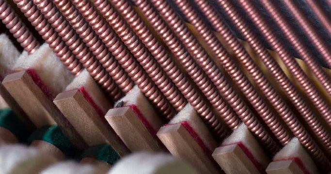 Jazz Strings Piano. Piano hammers covered with soft felt, striking the strings inside the instrument