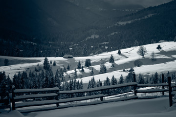 winter in the mountains - small Romanian village in the Carpathians covered with snow