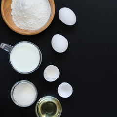 Ingredients for cooking on black background. Recipe of Russian pancakes