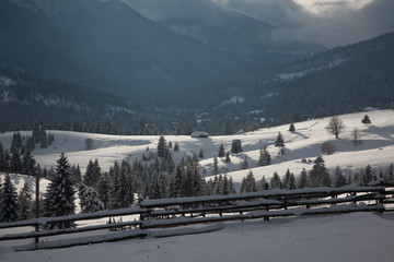 winter in the mountains - small Romanian village in the Carpathians covered with snow