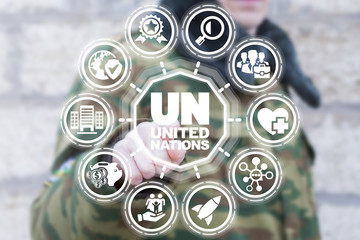 Soldier using virtual interface presses text button un united nations. UN -
 United Nations Unies...