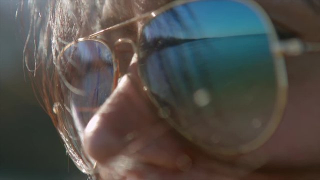 Closeup of the woman wearing sunglasses.