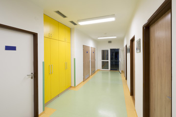 empty hospital corridor with yellow cabinet