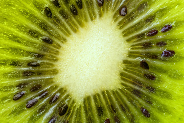 Heart of kiwi fruit with seeds close-up in a cut.