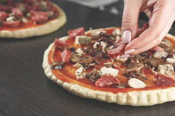 pizza cooking, meat of chiken, sausage salami, thick dough,  pizza crust, chef prepares delicious...